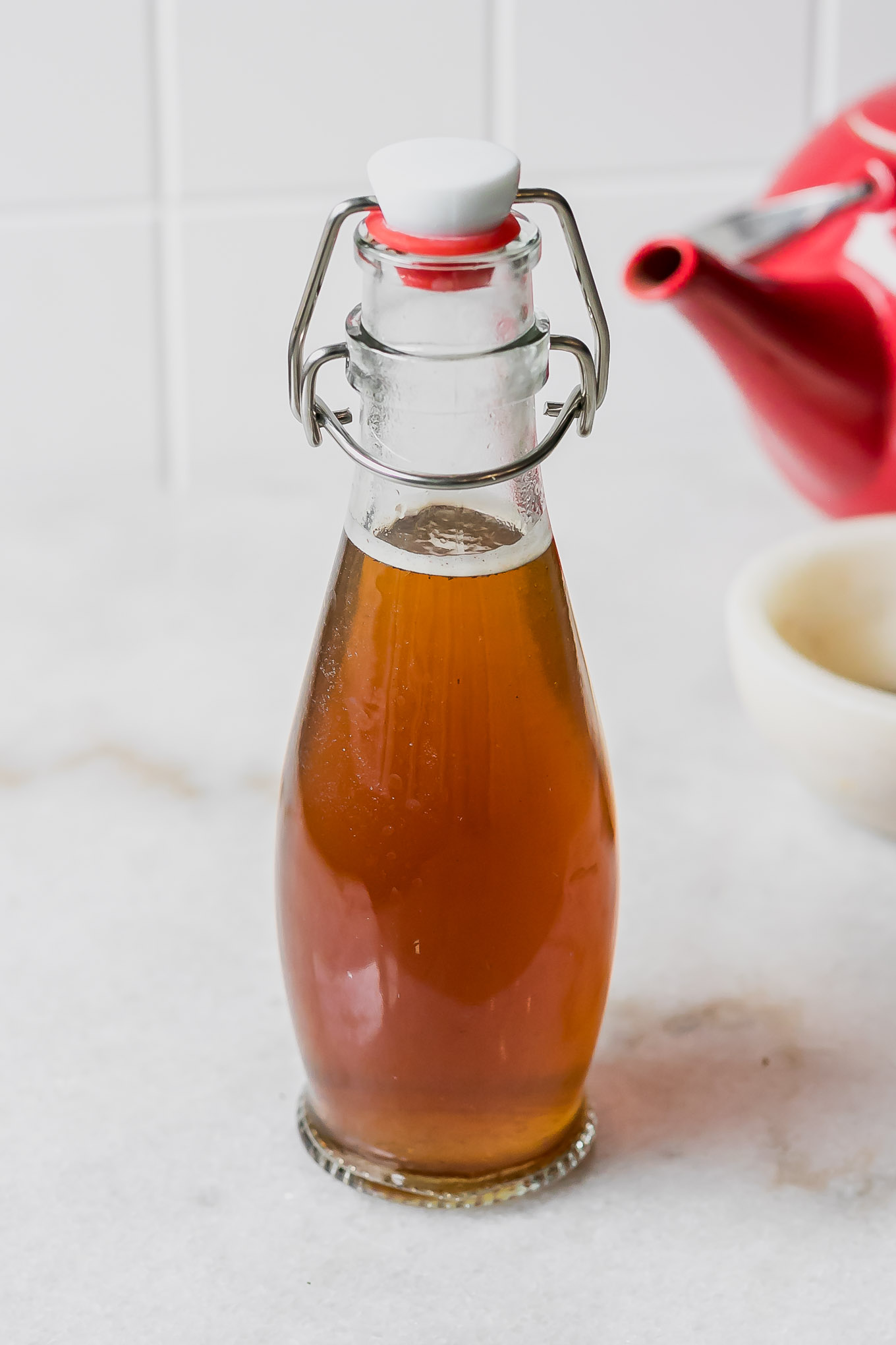 a jar of chai tea-infused simple syrup on a white countertop