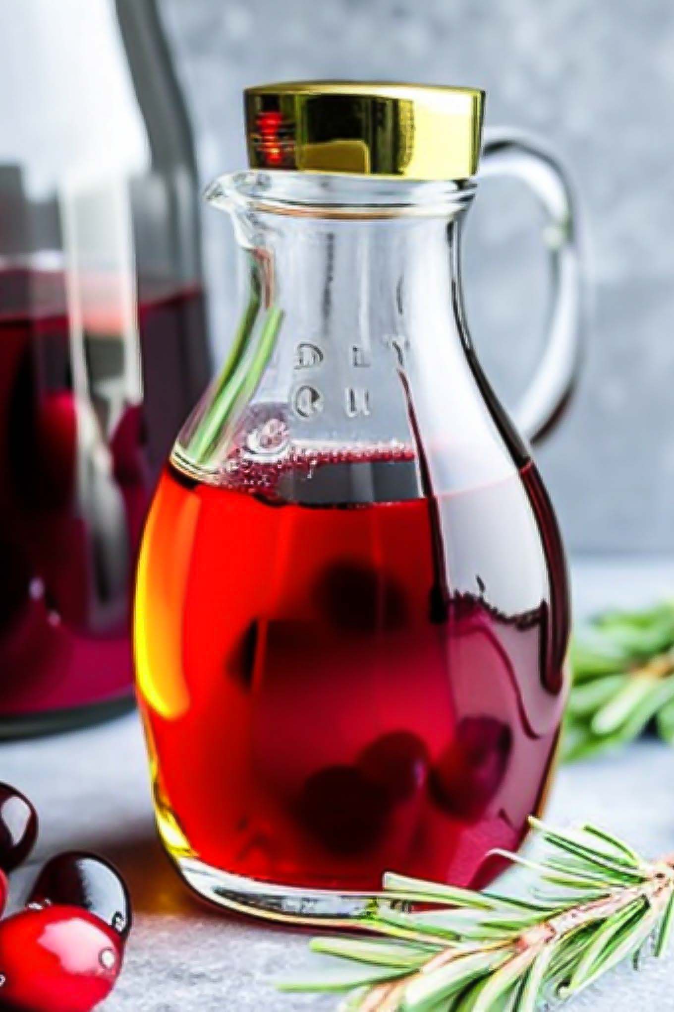 a jar of cranberry simple syrup in a glass jar on a blue table