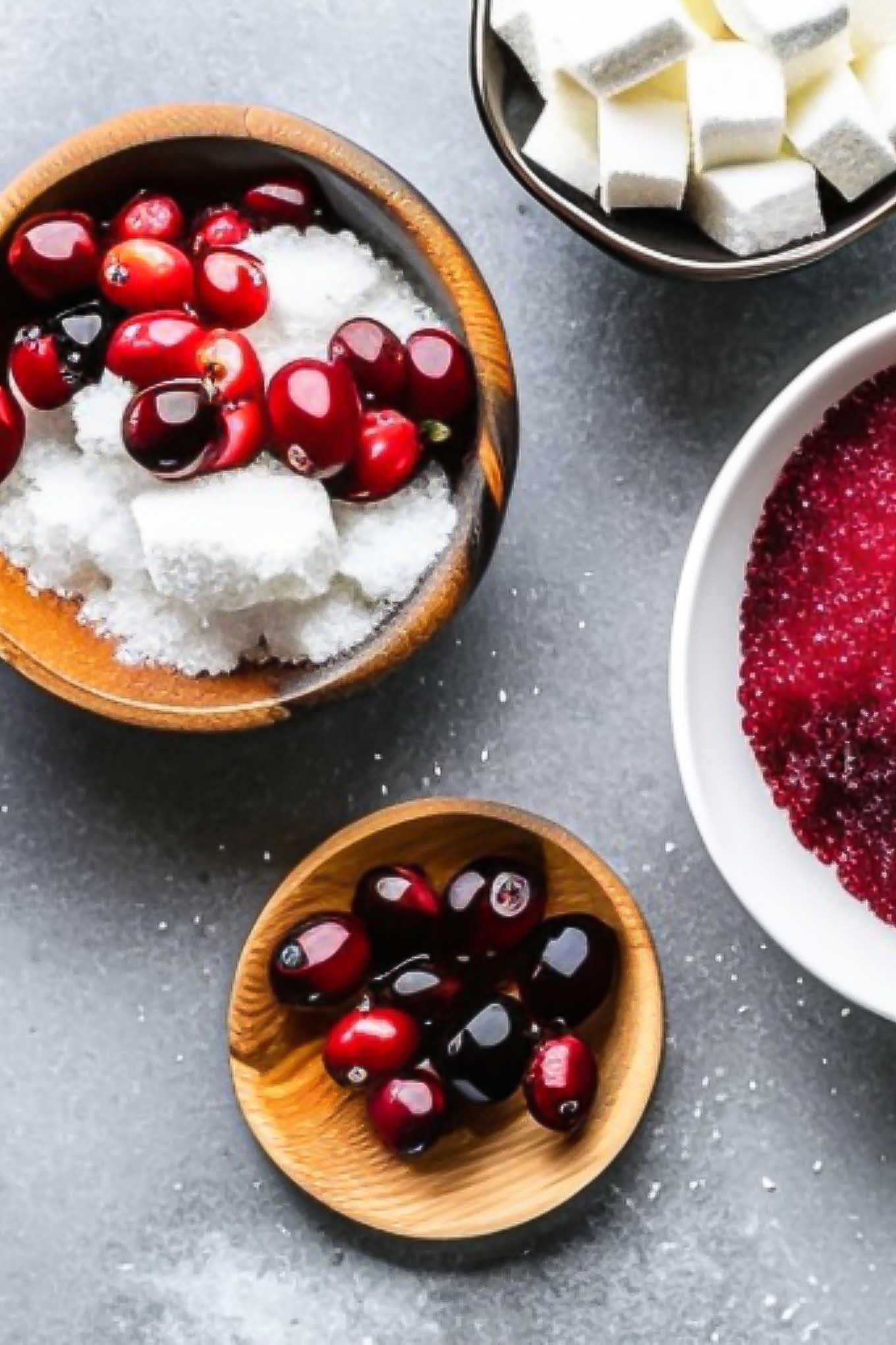 bowls of cranberries and sugar on a blue table