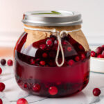 cranberry simple syrup in a glass jar